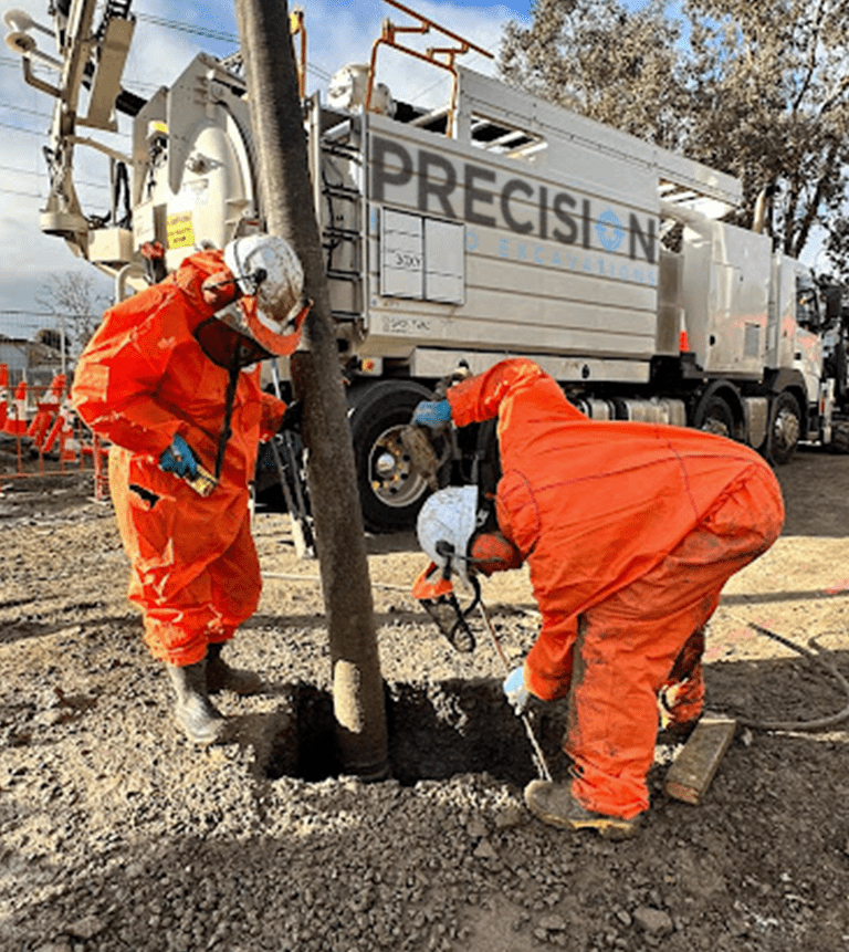 Two hydro excavation workers during a non destructive digging project